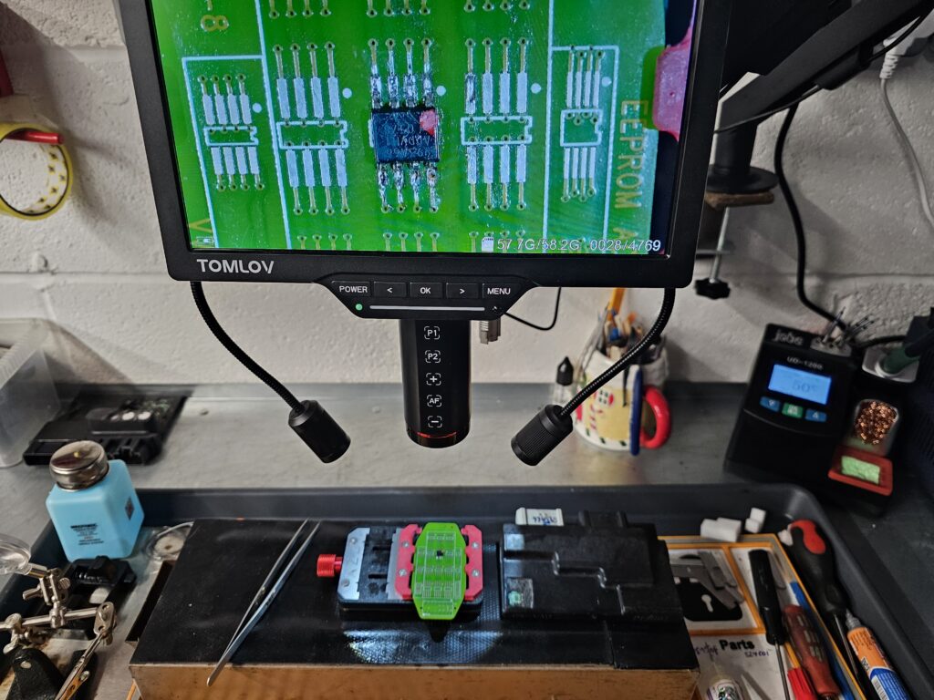 Honda CBF1000 ECU EEPROM chip under microscope during immobiliser key programming